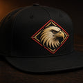 Black snapback with embroidered eagle crest